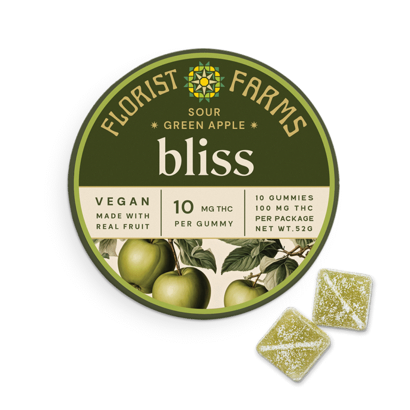 bliss-sour-green-apple-gummies-florist-farms: A vibrant close-up of Florist Farms' Sour Green Apple Gummies in their packaging, showcasing their appealing green color and texture.